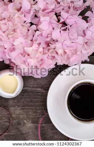 
fragrant coffee, pink hydrangea on a wooden garden table