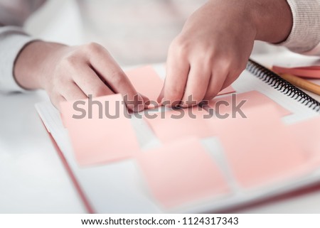 Working process. Conscious girl sitting at the workplace while preparing presentation Royalty-Free Stock Photo #1124317343