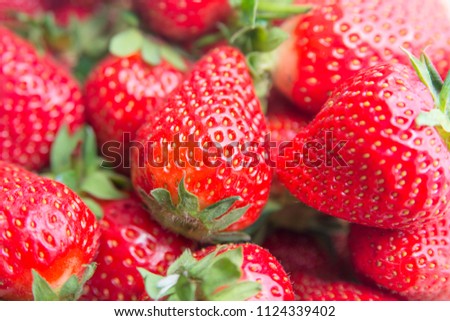 Macro photo of a ripe red large strawberry with a small depth of field