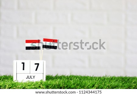 July 17 Wooden calendar and Iraq Flag Concept Iraq national day with space for your text
