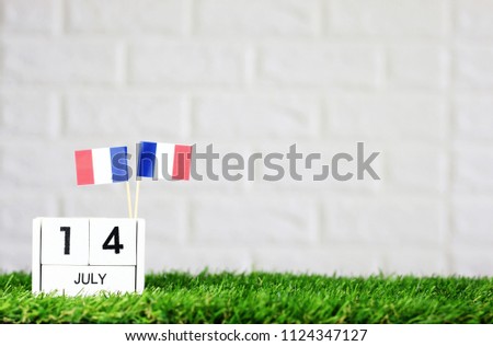 July 14 Wooden calendar and France Flag Concept France national day with space for your text