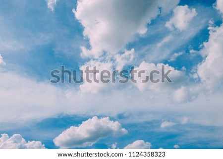 Blue sky. white fluffy clouds in the blue sky. clear blue sky with plain white cloud with space for text background. 
