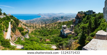 Panoramic view to Tyrrhenian coastline with Cofano mount, Church of Saint John the Baptist and Torretta Pepoli from Erice town, Trapani region, Sicily, Italy Royalty-Free Stock Photo #1124371433