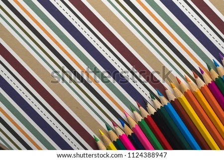 different types of business, school and office accessories on colorful geometric paper background