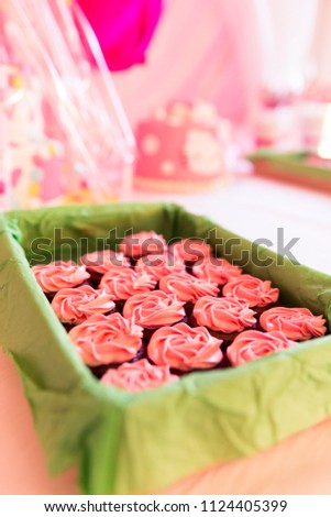 Pink Sugar Coated Cup Cakes in Green Basket and Blurred Background