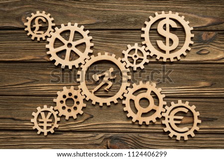 gears. currency, office worker on a wooden background. business. finance