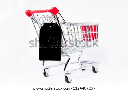 Modern stainless shopping cart with a price tag beside close up.