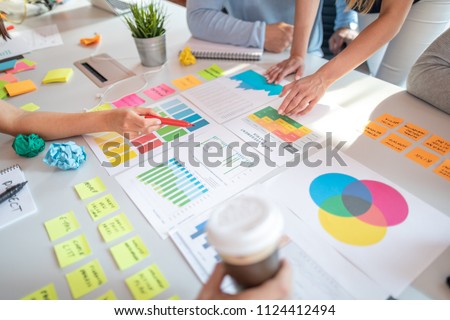 Business people meeting at office and use post it notes to share idea. Brainstorming concept. Sticky note on glass wall. Royalty-Free Stock Photo #1124412494