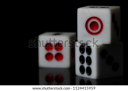 Closeup three dice stacked on dark background. Casino or business concept.