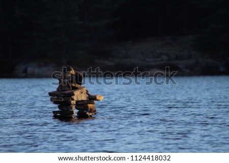 inukshuk standing in a lake