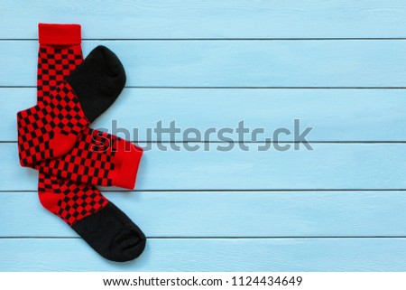 Pair of colorful socks  on a wooden background.