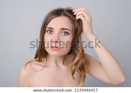 Make-up lack of vitamins minerals quick dirty hairstyle concept. Close up photo portrait of sad upset troubled lady holding brittle unhealthy brunette dyed curls in hand isolated on grey background
