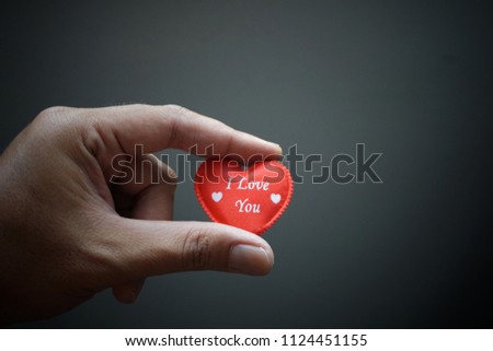 Hand holding the red heart symbol with word I Love You. Soft and vintage background image.