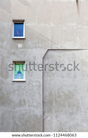 picture of an unpainted house wall with windows