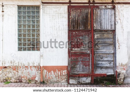 picture of an old building with a weathered wooden sliding door