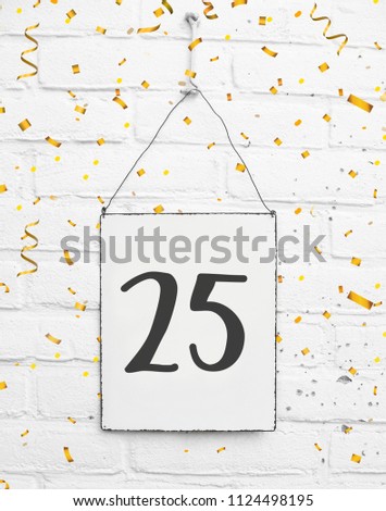 25 years old birthday party card text with golden confetti, number twenty-five, metal plate white brick background