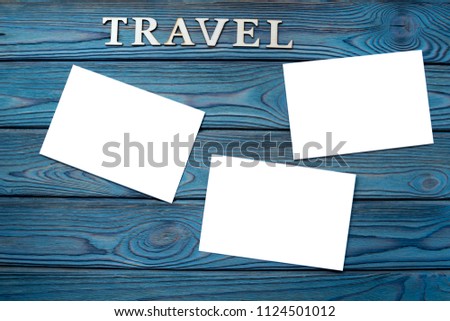 word travel, photo paper with white space on a wooden background. memories of the journey.