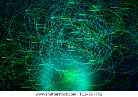 Abstract green color light trails shot with long exposure at night. Light painting with circle effect.