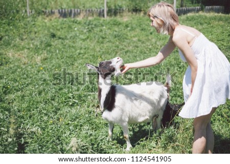 girl and goat in the countryside