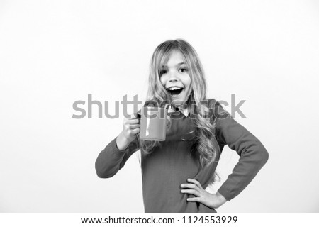 Tea or coffee break. Girl with long blond hair in red sweater with mug. Health and healthy drink. Child with surprised face hold blue cup on orange background. Thirst, dehydration concept.