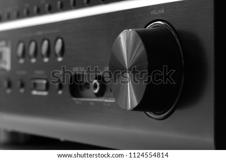 Front side of the AV receiver with volume knob close-up Royalty-Free Stock Photo #1124554814