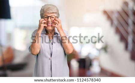 Beautiful senior woman very angry and upset, very tense, screaming furious, negative and crazy at home.