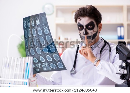 Scary monster doctor working in lab Royalty-Free Stock Photo #1124605043