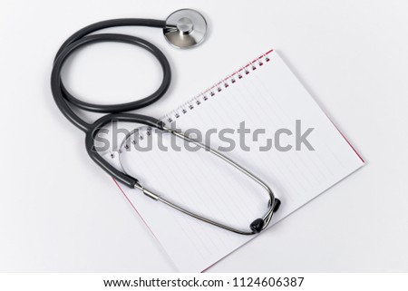 Medical concept with stethoscope on doctors notepad