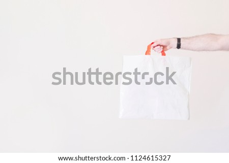Blank plastic bag white background arm stretch out holding recycle plastic non biodegradable