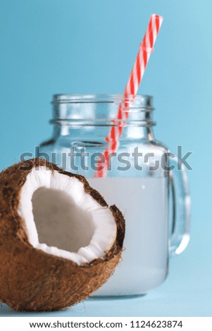 Fresh coconut cocktail on a blue background.