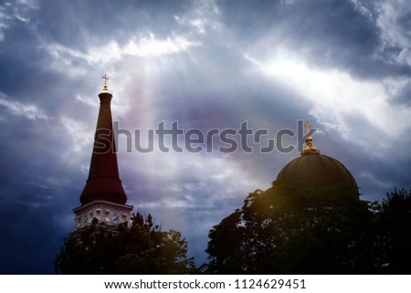 The domes of the church of the temple against the background of a beautiful sky with clouds.