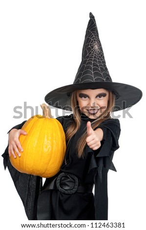Portrait of little girl in black hat and black clothing with pumpkin on white background