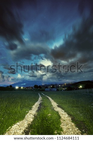 Landscape with night sky and a dirt road
