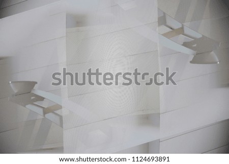While wall with two oppositely directed lamps on metal brackets. Reworked photo of modern architecture fragment in minimalist style. Abstract interior background with parallel shadows.