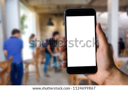 A woman hand holding smart phone device in cafe 

