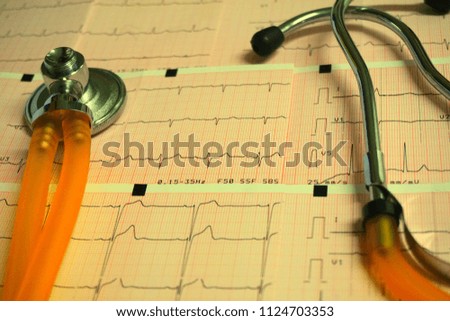 Healthy concept: stethoscope and electrocardiogram (ECG, EKG) in paper form
