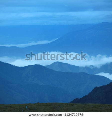 Fog and clouds in the mountains in the early morning, soft light