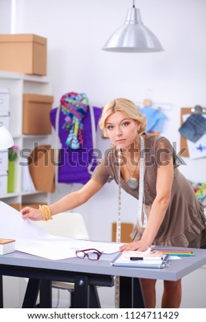 Young woman fashion designer working at studio.