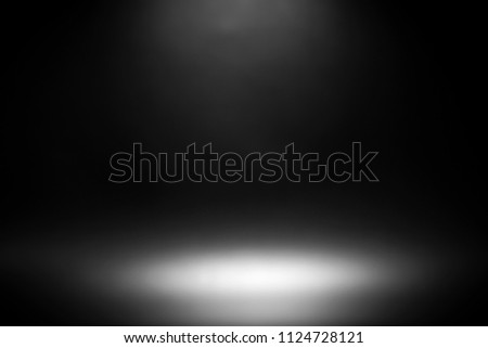 blurred abstract light on black background for product showcase.