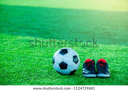 Football and Sports shoes on artificial turf.