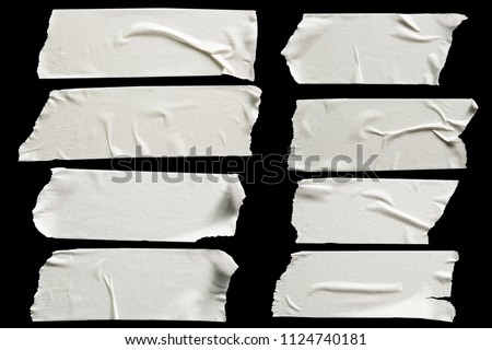 Set of white scotch tapes on black background. Torn horizontal and different size white sticky tape, adhesive pieces. Royalty-Free Stock Photo #1124740181