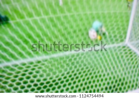 Soccer players at the pitch. Blurred soccer game.
