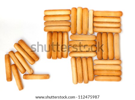 vertical and horizontal rows of bread sticks on white Royalty-Free Stock Photo #112475987