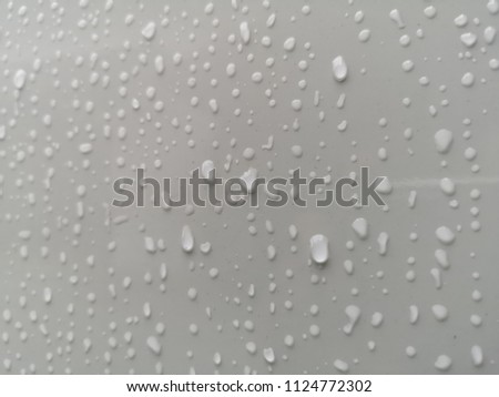 water drop on white surface  