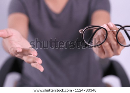 Male index finger holding contact lens.
