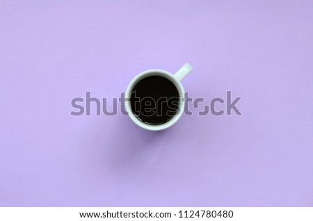 Small white coffee cup on texture background of fashion pastel violet color paper in minimal concept
