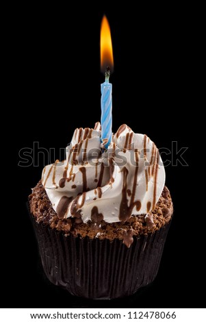 Studio shot of a cupcake, on a black background.