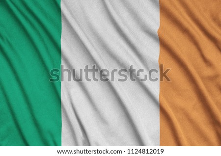 Ireland flag  is depicted on a sports cloth fabric with many folds. Sport team banner