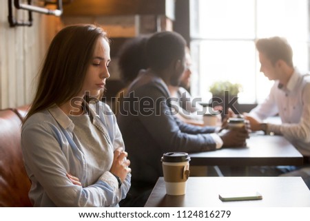 Upset girl ghosted by boyfriend, waiting for him alone in coffeeshop, frustrated female rejected by admirer or lover, wasting time for cancelled date, sad outcast jealous of happy friends in cafe, Royalty-Free Stock Photo #1124816279