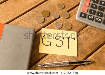 Good service and tax .  Notepad, pen, coins, calculator on wooden background .